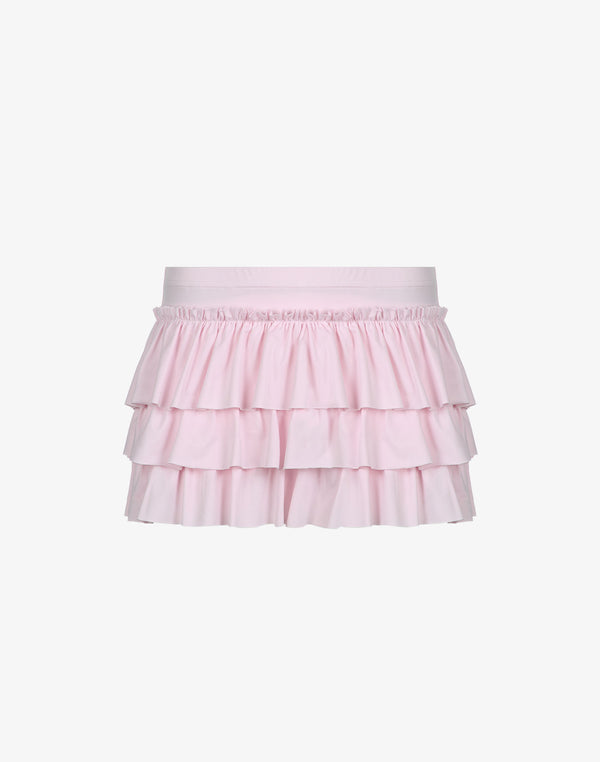 Studio shot of the pink tiered ruffle mini skirt, shown without the optional bow.