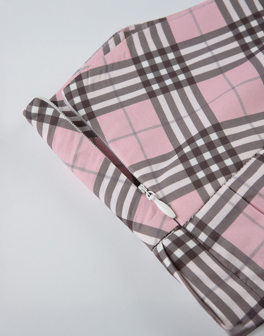 Detailed view of the pink and black tartan pattern, central to the 2000s campus style.