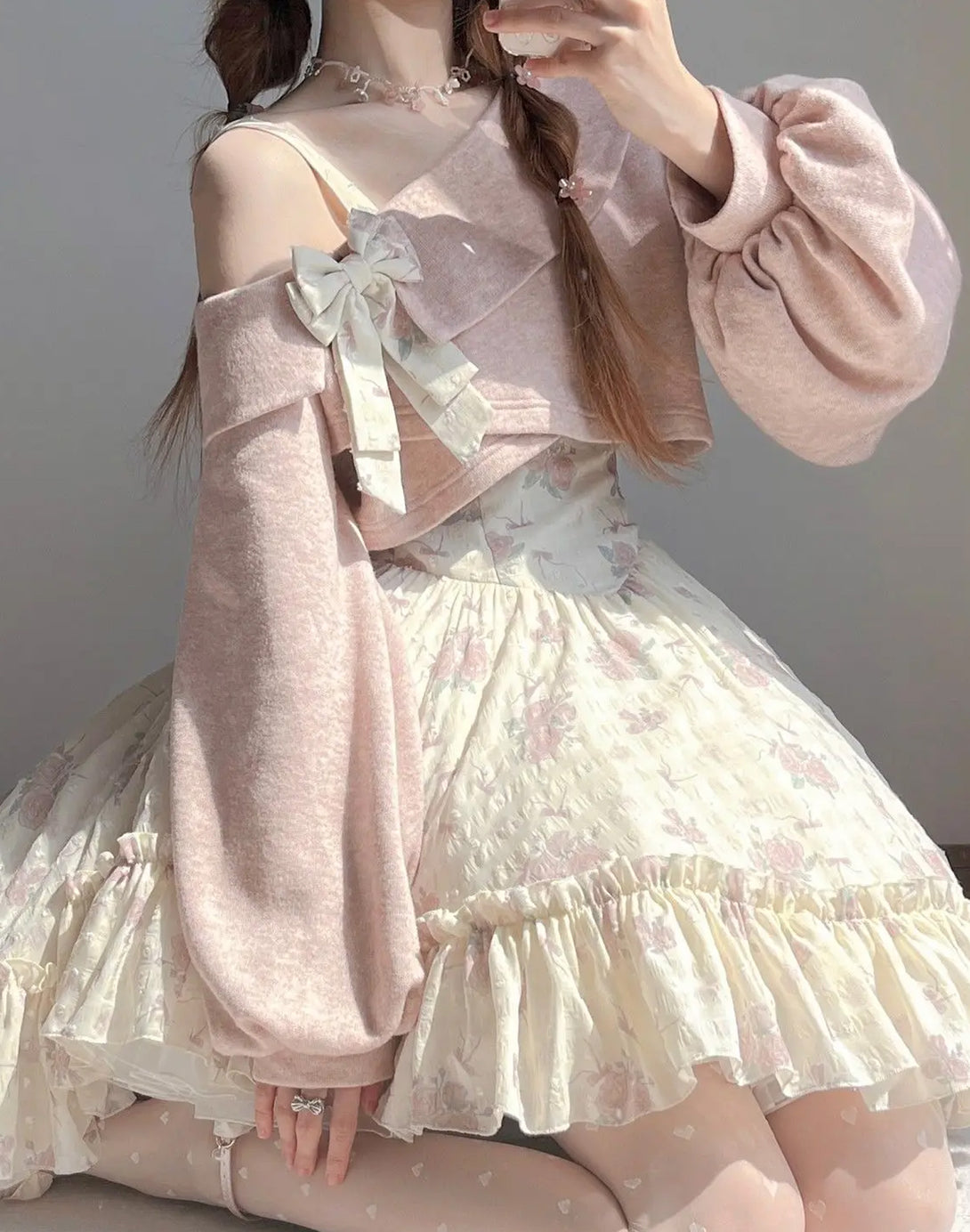Soft pink coquette style dress with bow detail, ruffled skirt, and cozy shrug, ideal for hyper feminine fashion lovers.