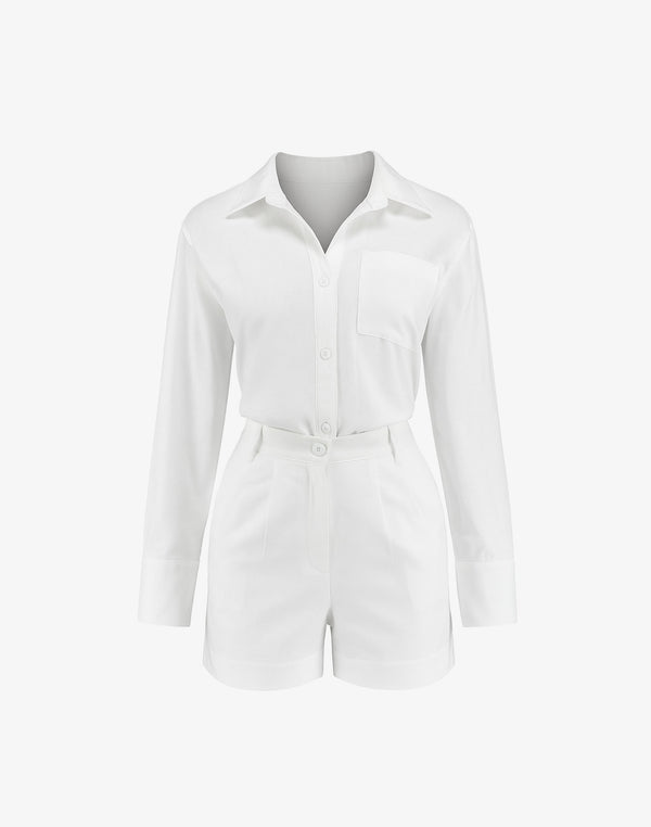 Flat lay of white long sleeve button-up romper with collared neckline and tailored shorts, styled for feminine formalwear