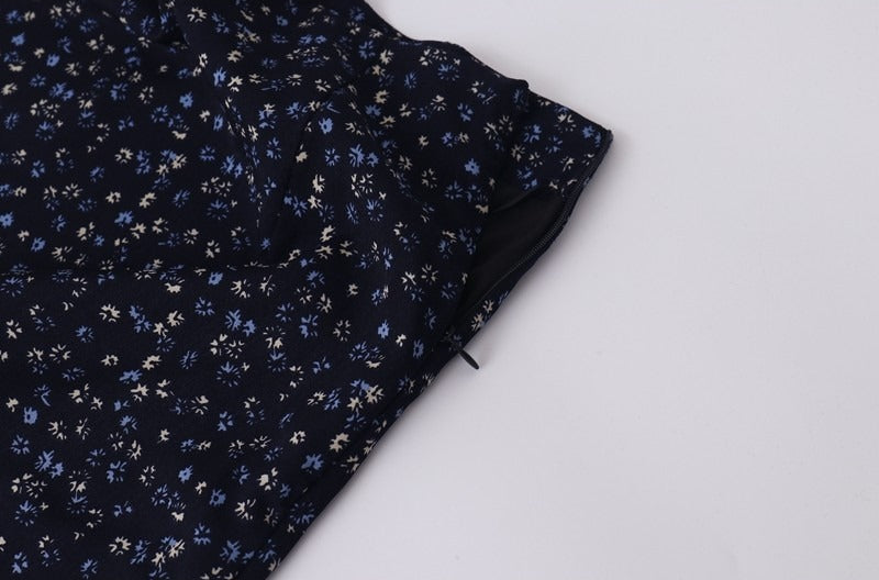 invisible side zipper detail on navy floral midi skirt with high-waisted design