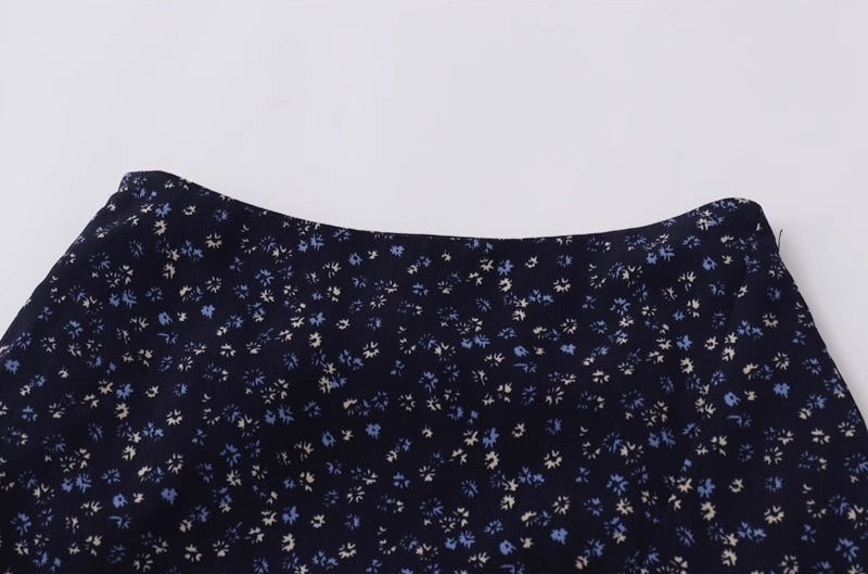 clean high-waisted waistband on bias-cut floral midi skirt with vintage print
