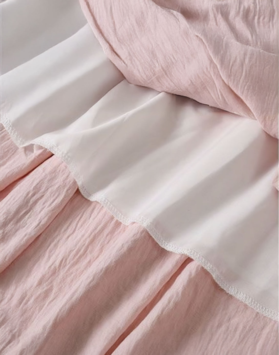 The interior of the skirt, showing the soft white lining beneath the pink tiered fabric for full coverage.