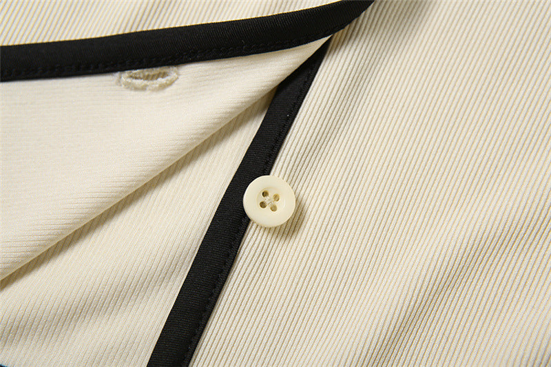 Button and piping detail on cream stretch knit fabric from feminine fashion coord set