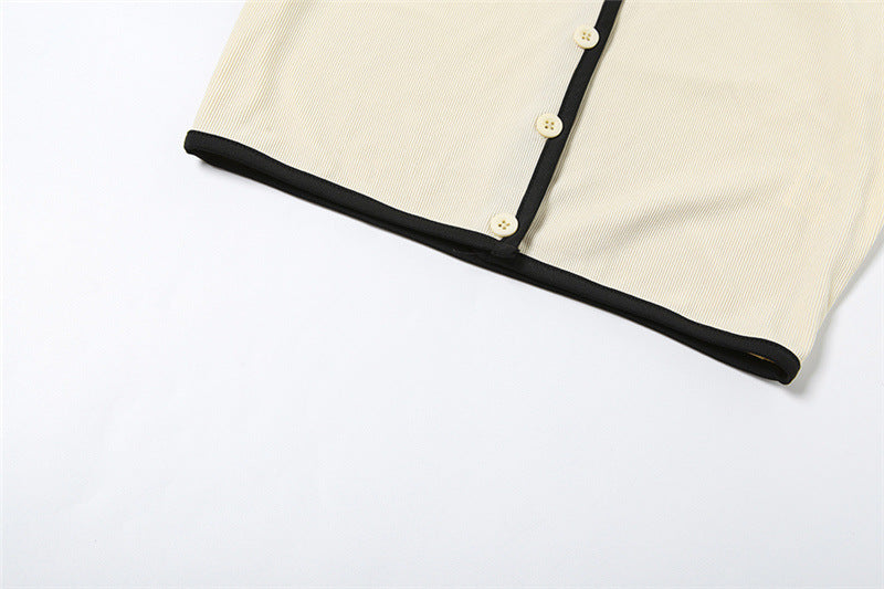 Close-up of mini skirt hem with black contrast trim laid flat on white background