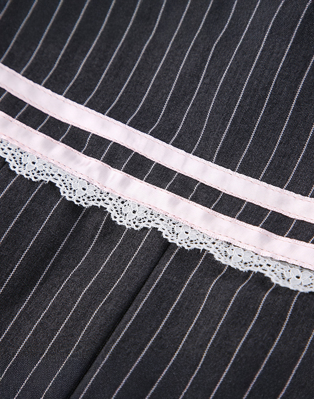 Detailed view of the delicate white lace trim beneath the pink stripe, adding to the skirt's feminine fashion aesthetic.