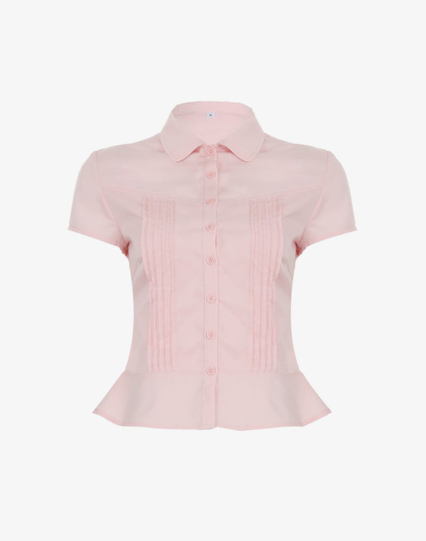 Studio shot of the Plain Ruffled Hem Blouse in pink, showing its ladies fitted cut and pintuck details.