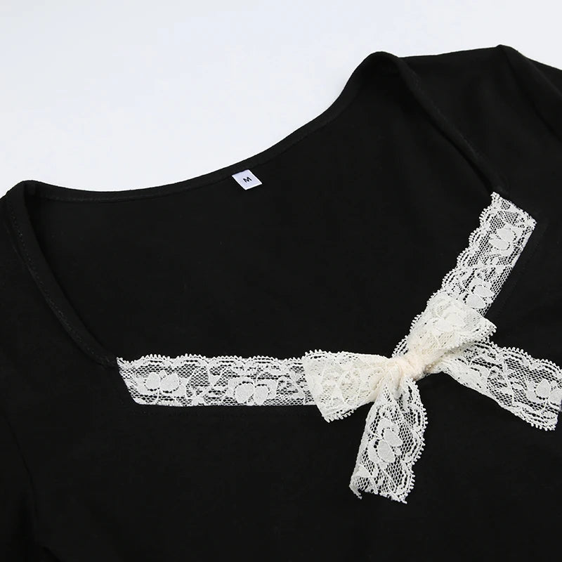 Detailed view of the intricate cream lace bow at the neckline, embodying a feminine romantic style.