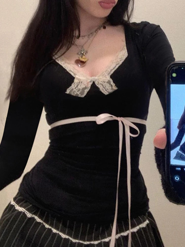 A woman wearing a complete dollette outfit, featuring the fitted long sleeve top with a dark skirt.