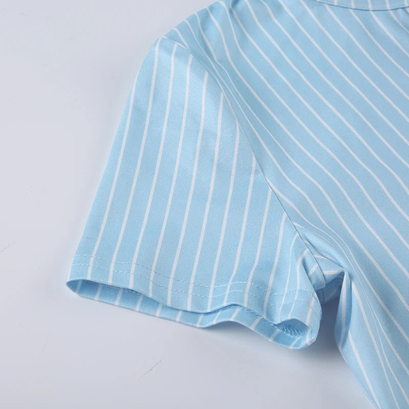 short sleeve close-up of light blue fitted shirt with crisp feminine structure
