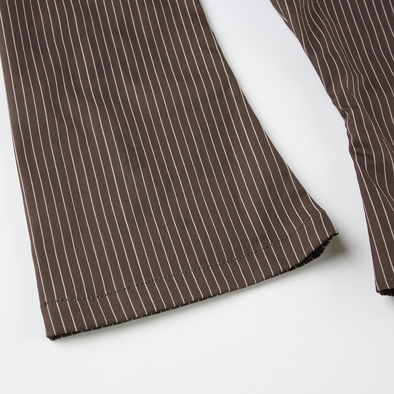 A closeup showcasing the dramatic flare of the bell sleeve on the pinstripe blouse.