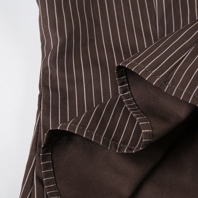 Interior seam detail of the flared sleeve on the brown pinstripe blouse.