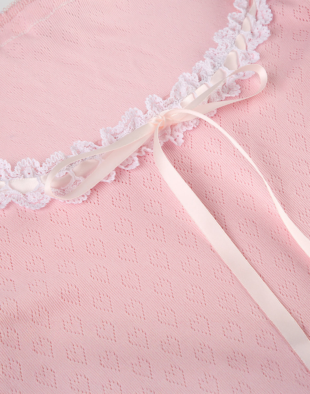 Close-up of the front tie ribbon and lace trim details of the Sweetheart Kawaii Lace Trim Top, emphasizing the hyper feminine elements.
