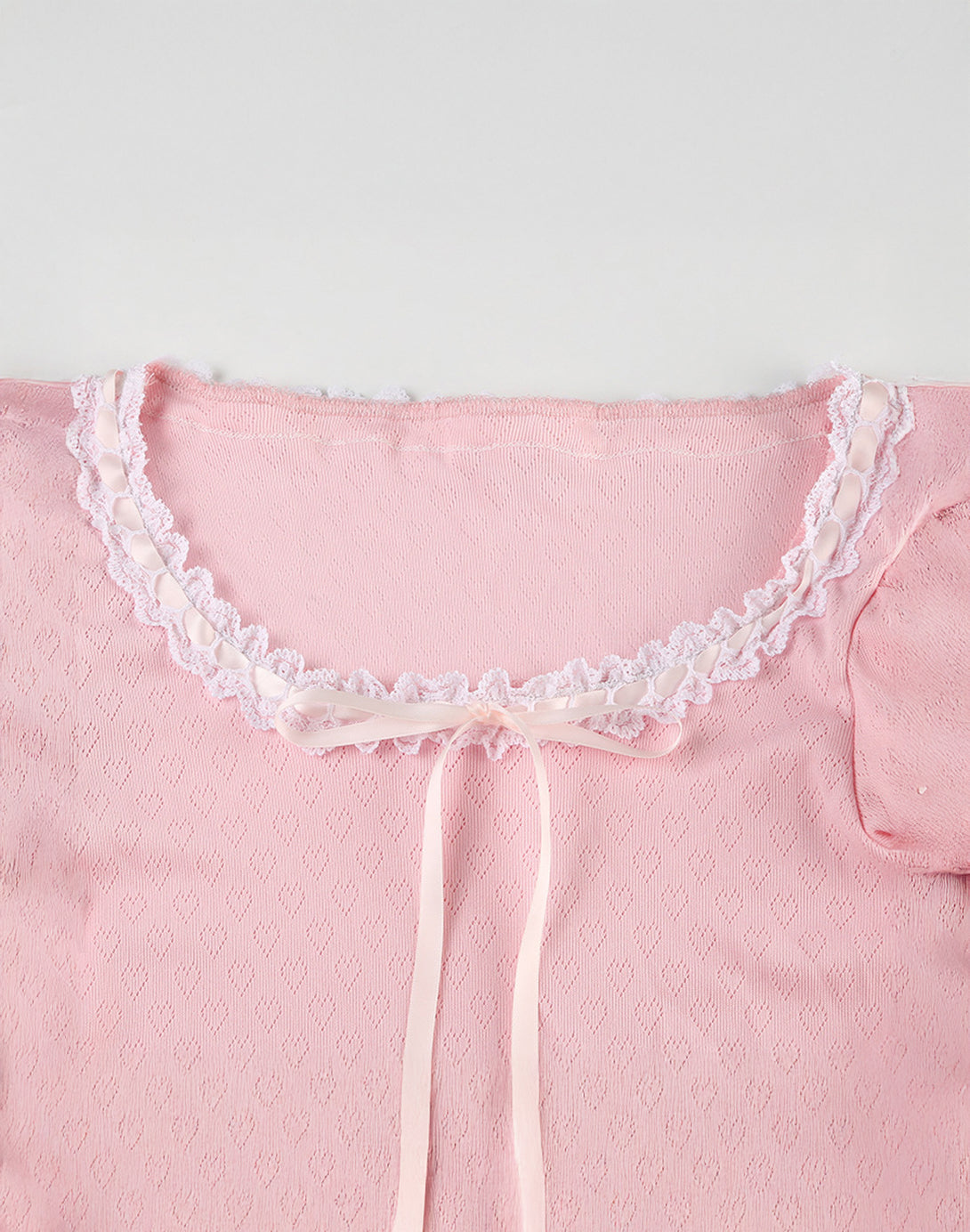 Close-up of the Sweetheart Kawaii Lace Trim Top showing the ruched front, lace trim on the neckline, and the front tie ribbon for a playful dollette outfit look.