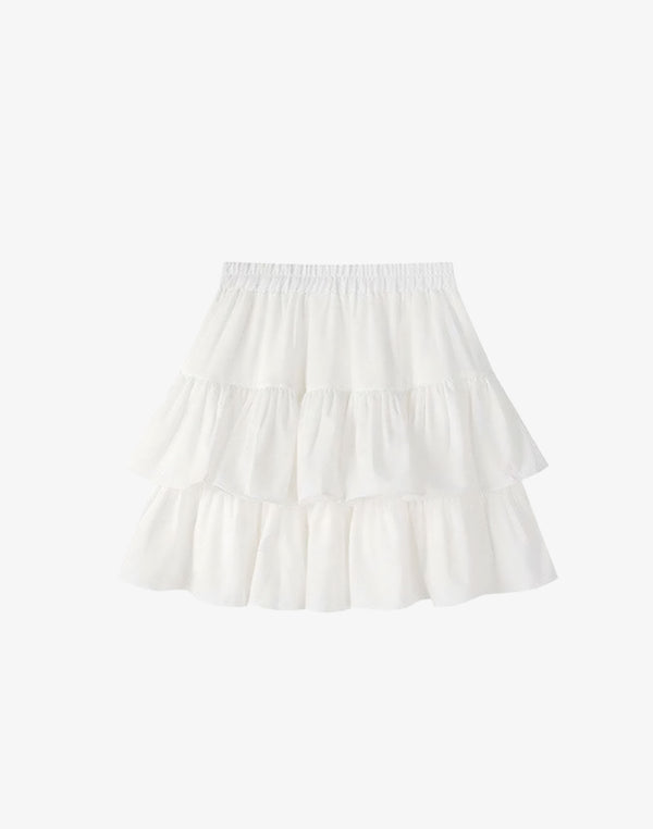 Studio shot of the white version of the tiered ruffle skirt mini, a staple for hyper feminine fashion.