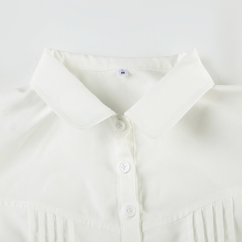 Closeup of the collar and delicate pintuck detailing on the white version of the fitted blouse.