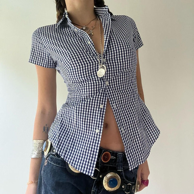 A woman styles the blue gingham shirt for a casual fashion look, worn open with jeans and a statement belt.