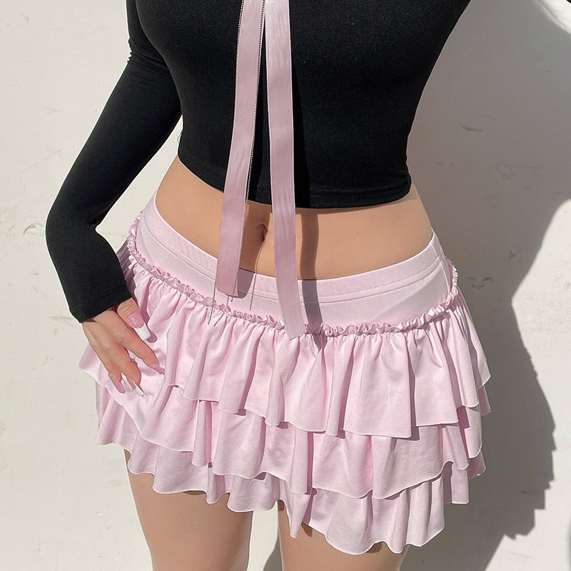 The pink tiered ruffle mini skirt styled with its large, matching bow for a full coquette look.