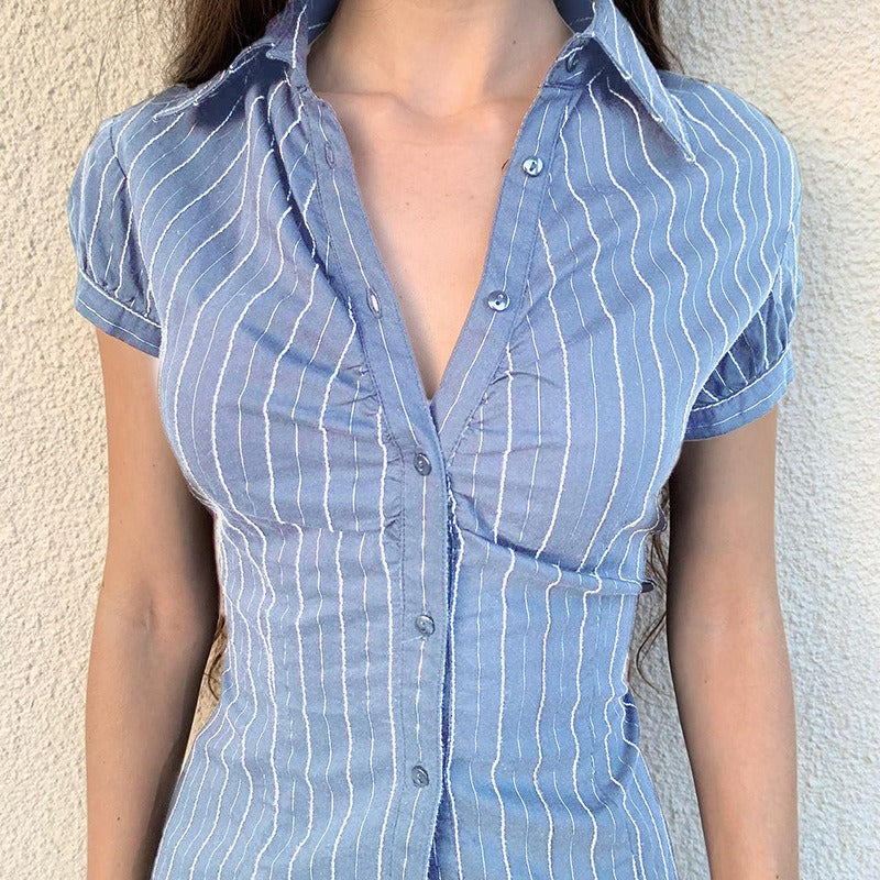 A woman wears the blue pinstripe blouse styled as a chic casual shirt with an open collar.
