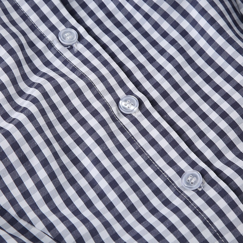 A detailed view of the classic blue gingham check pattern, a staple of feminine fashion.
