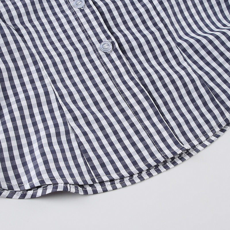 The curved shirttail hem of the ladies fitted blue gingham blouse.
