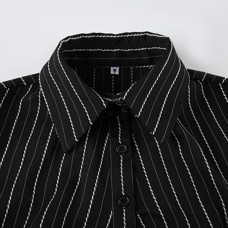Detailed shot of the classic pointed collar and pinstripe fabric of the formal blouse.