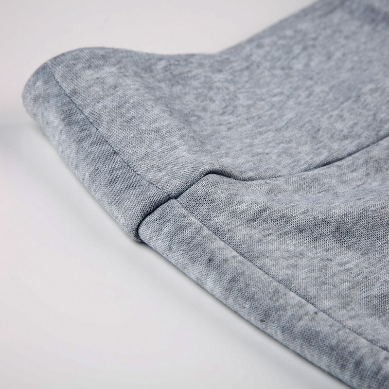 A closeup of the soft, fleece-lined fabric of the grey wide leg joggers.